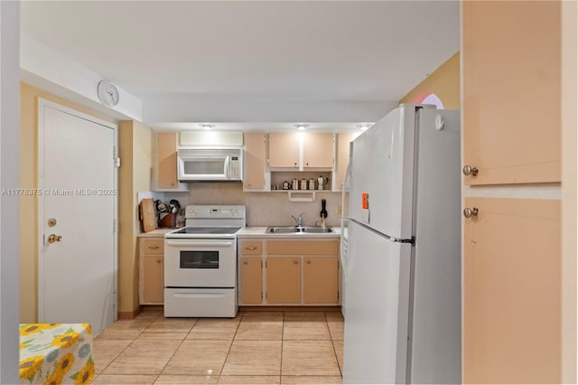 kitchen with light tile patterned floors, open shelves, a sink, light countertops, and white appliances