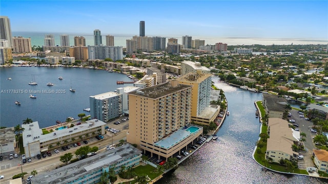 birds eye view of property featuring a water view and a view of city