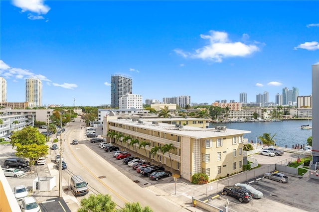 drone / aerial view featuring a water view and a view of city