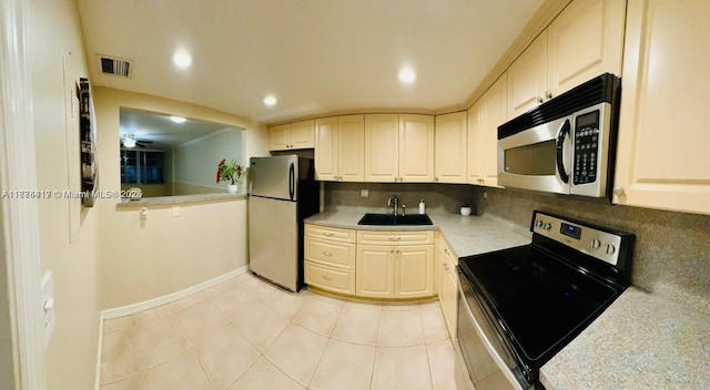 kitchen featuring visible vents, a sink, light countertops, stainless steel appliances, and decorative backsplash