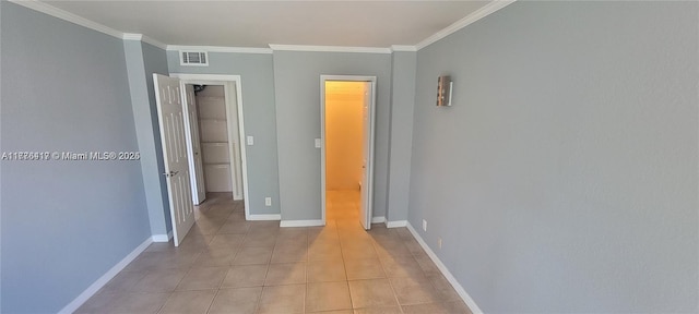 unfurnished bedroom with visible vents, baseboards, crown molding, and light tile patterned flooring