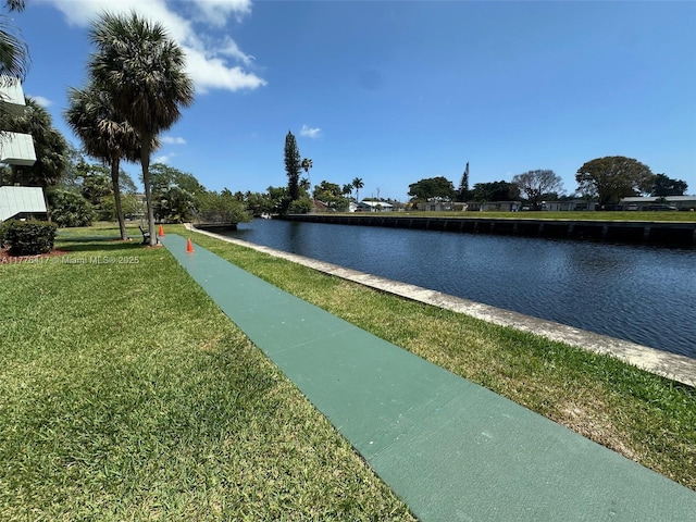 surrounding community featuring a water view and a yard