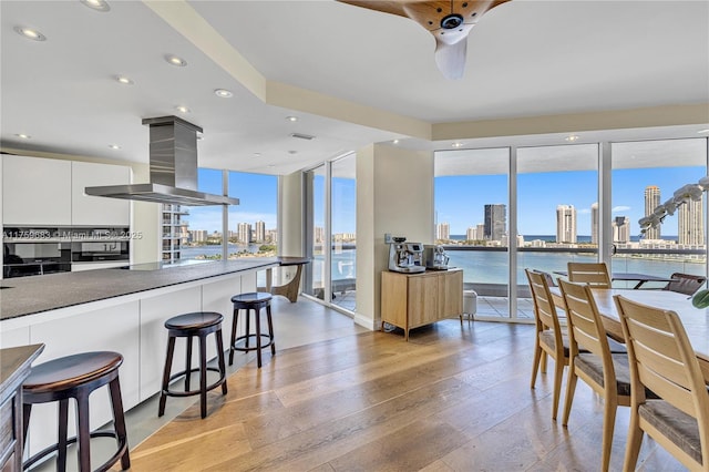 2600 E Island Blvd Unit 1704, Aventura, FL 33160 - dining area with a skyline view, light wood-style floors, expansive windows, recessed lighting, and a ceiling fan
