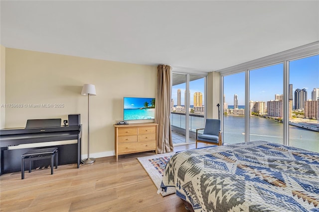 2600 E Island Blvd Unit 1704, Aventura, FL 33160 - bedroom featuring access to outside, wood finished floors, baseboards, and expansive windows