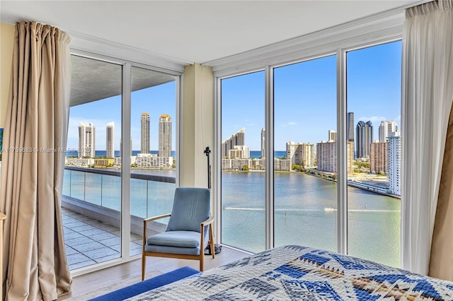 2600 E Island Blvd Unit 1704, Aventura, FL 33160 - bedroom with a wall of windows, a skyline view, access to exterior, a water view, and wood finished floors
