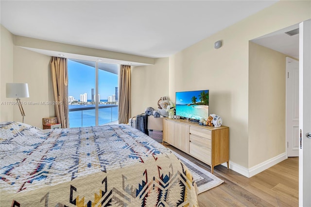 2600 E Island Blvd Unit 1704, Aventura, FL 33160 - bedroom featuring access to outside, light wood-style floors, and baseboards