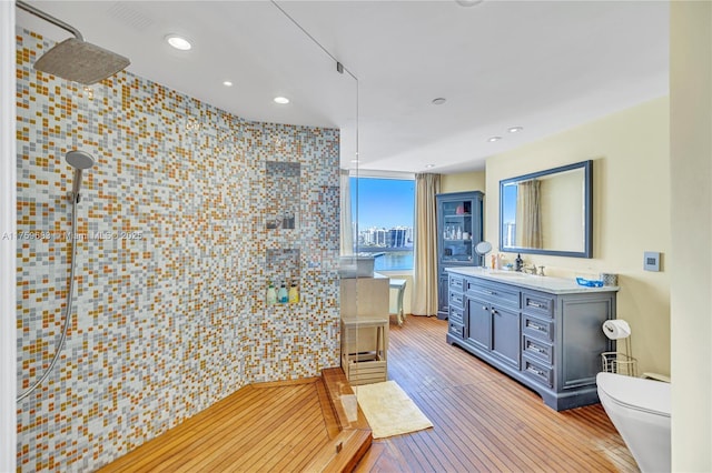 2600 E Island Blvd Unit 1704, Aventura, FL 33160 - bathroom with tiled shower, vanity, wood-type flooring, recessed lighting, and toilet