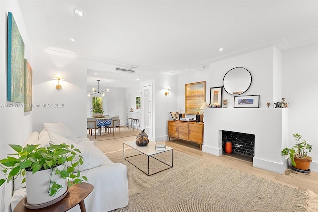 living room featuring recessed lighting, visible vents, and wood finished floors