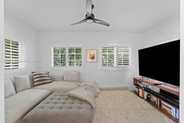 living area with ceiling fan, carpet, and baseboards