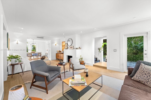 living area featuring recessed lighting, stairway, light wood-style floors, and a healthy amount of sunlight