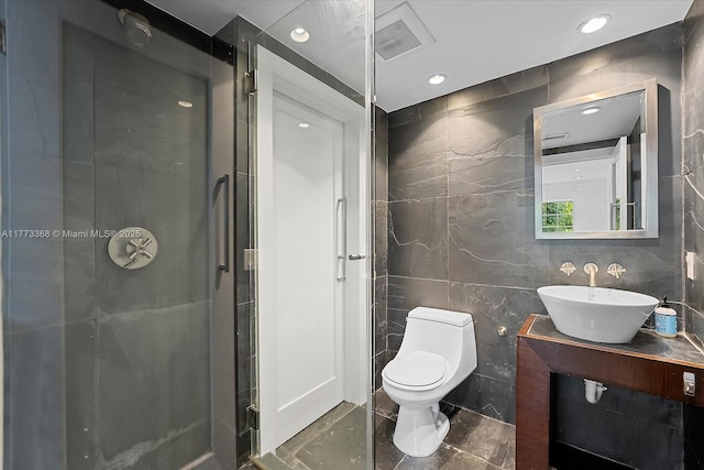full bathroom with a shower stall, toilet, recessed lighting, and tile walls