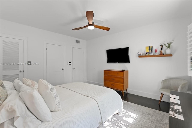 bedroom featuring baseboards, a ceiling fan, and visible vents