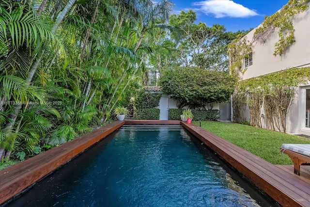 view of swimming pool featuring a yard and a fenced backyard