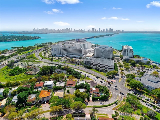 birds eye view of property with a water view and a city view