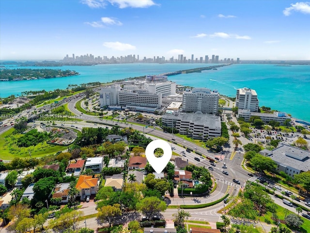 birds eye view of property featuring a view of city and a water view