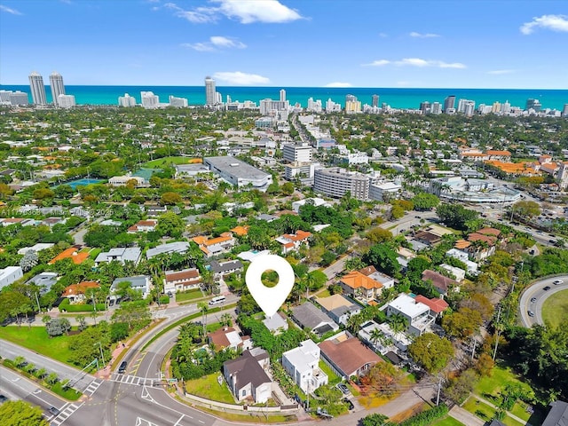 birds eye view of property with a water view and a view of city