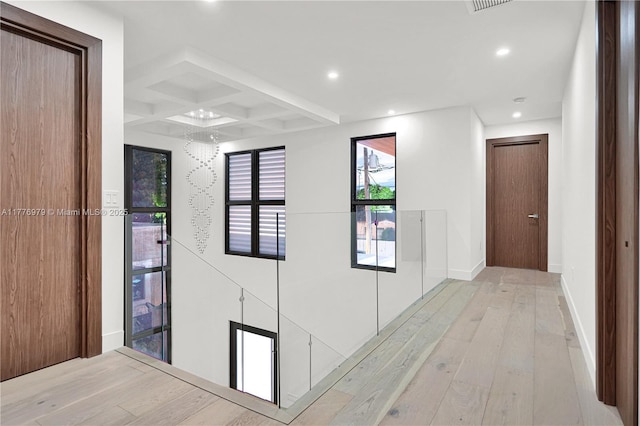 hallway with beamed ceiling, recessed lighting, coffered ceiling, baseboards, and hardwood / wood-style flooring