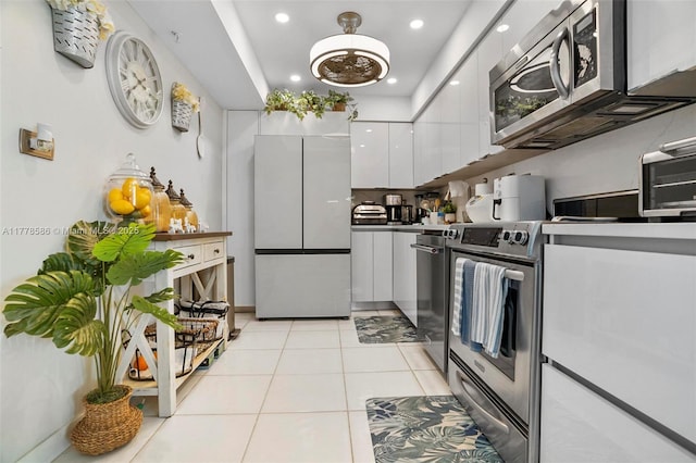 20355 NE 34th Ct Unit 2326, Aventura, FL 33180 - kitchen featuring stainless steel appliances, white cabinetry, modern cabinets, recessed lighting, and light tile patterned floors