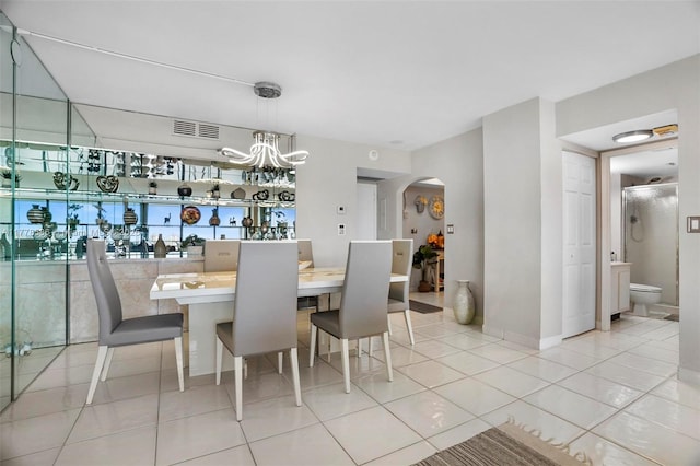 20355 NE 34th Ct Unit 2326, Aventura, FL 33180 - dining space featuring arched walkways, tile patterned flooring, and a chandelier
