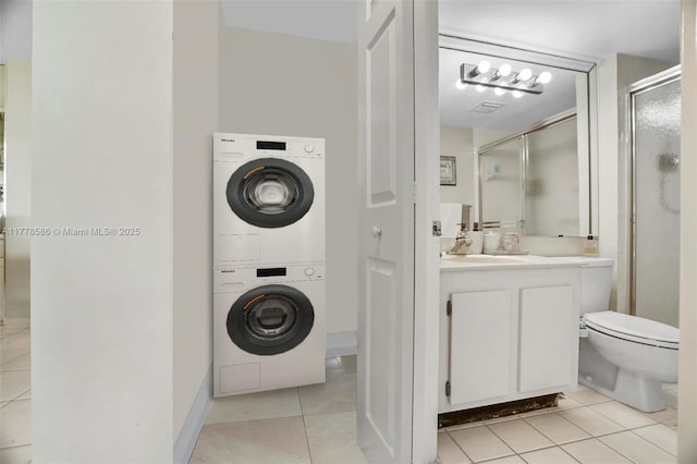 20355 NE 34th Ct Unit 2326, Aventura, FL 33180 - full bath featuring stacked washer / dryer, tile patterned flooring, a stall shower, and vanity