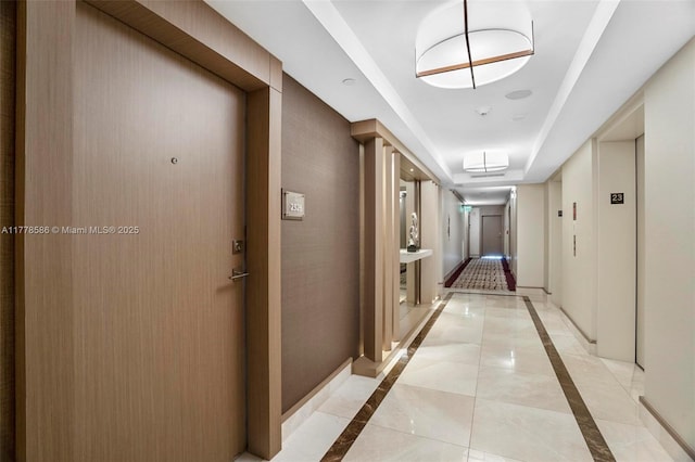 20355 NE 34th Ct Unit 2326, Aventura, FL 33180 - corridor featuring inlaid floor details, light tile patterned floors, and a raised ceiling