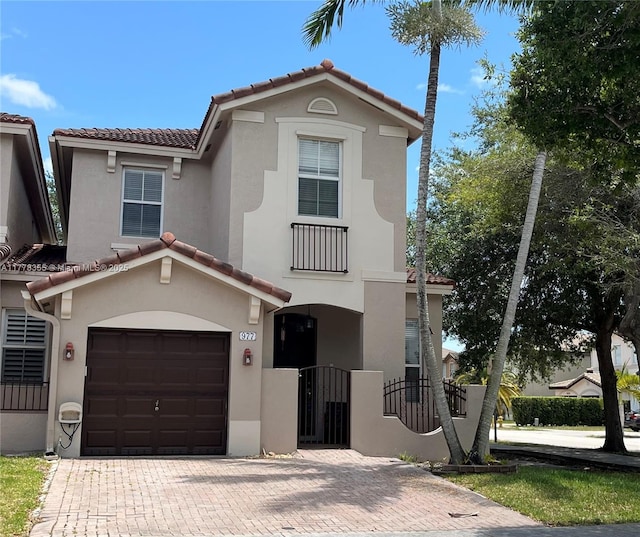 977 SW 153rd Path, Miami, FL 33194 - mediterranean / spanish home featuring a tiled roof, stucco siding, an attached garage, and decorative driveway