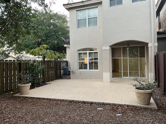 977 SW 153rd Path, Miami, FL 33194 - back of property with stucco siding, a patio, and a fenced backyard