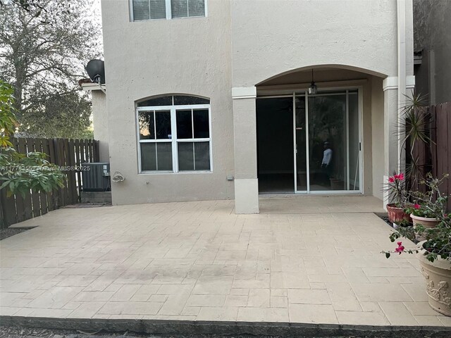 977 SW 153rd Path, Miami, FL 33194 - back of property with stucco siding and a patio area