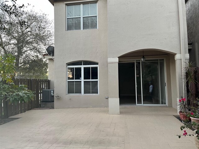 977 SW 153rd Path, Miami, FL 33194 - back of property with a patio, stucco siding, and central AC unit
