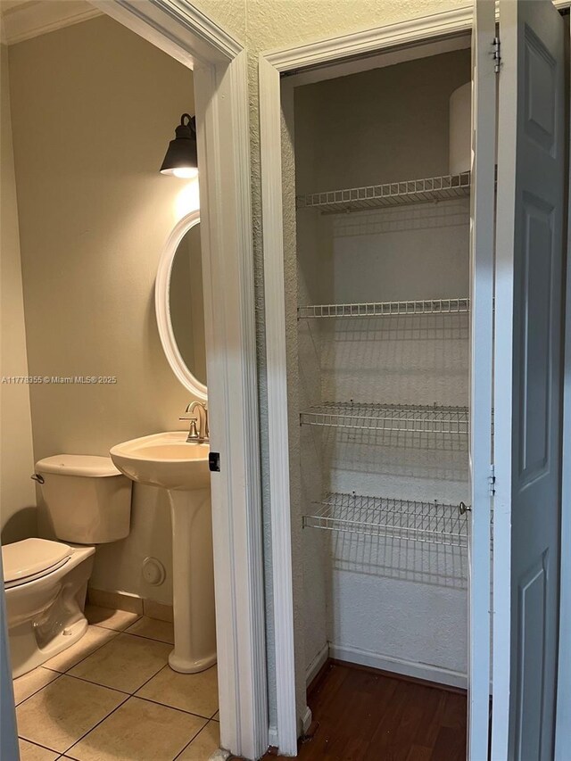 977 SW 153rd Path, Miami, FL 33194 - bathroom featuring toilet, baseboards, tile patterned floors, and a sink