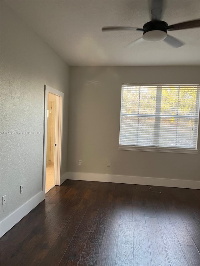 977 SW 153rd Path, Miami, FL 33194 - empty room featuring dark wood-style flooring, a ceiling fan, and baseboards