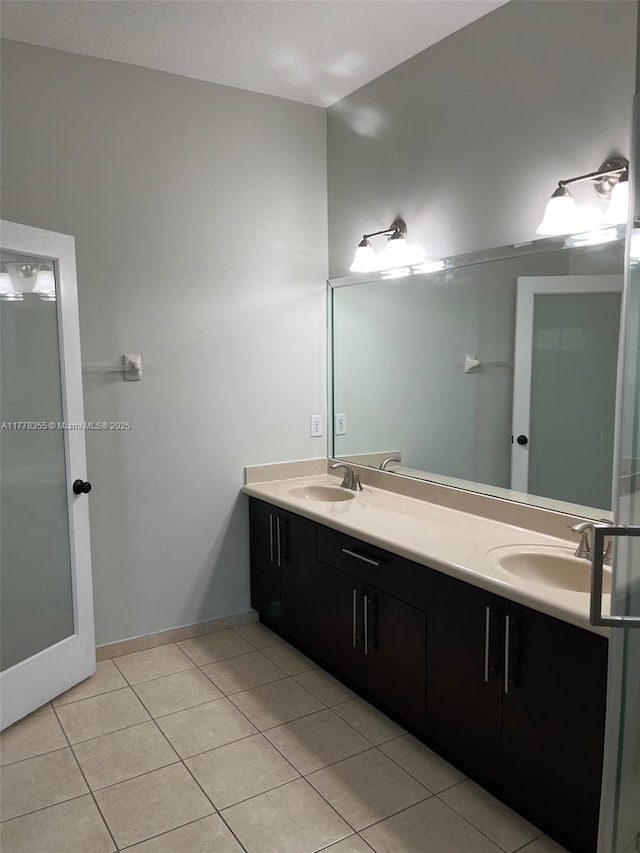 977 SW 153rd Path, Miami, FL 33194 - bathroom featuring double vanity, tile patterned flooring, and baseboards