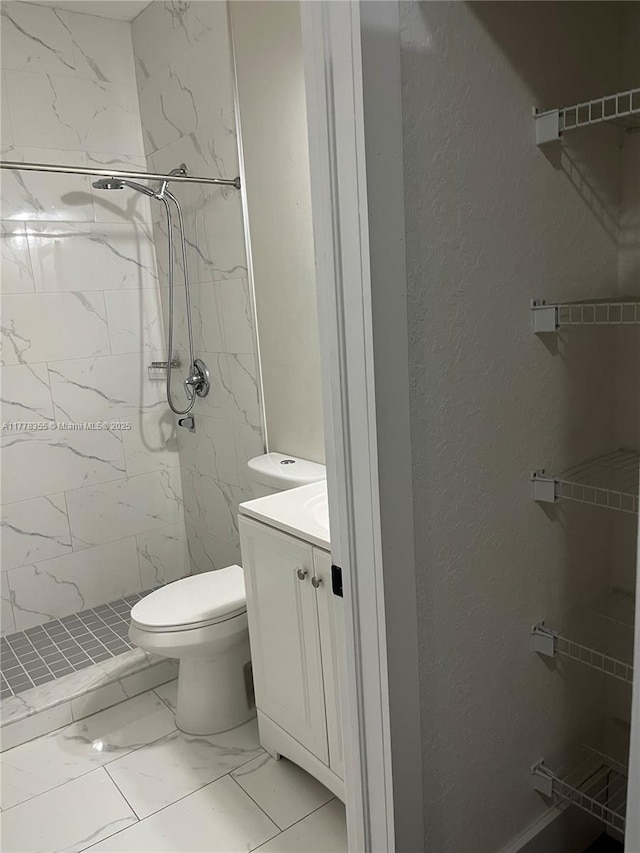 977 SW 153rd Path, Miami, FL 33194 - bathroom with vanity, toilet, marble finish floors, a marble finish shower, and a textured wall