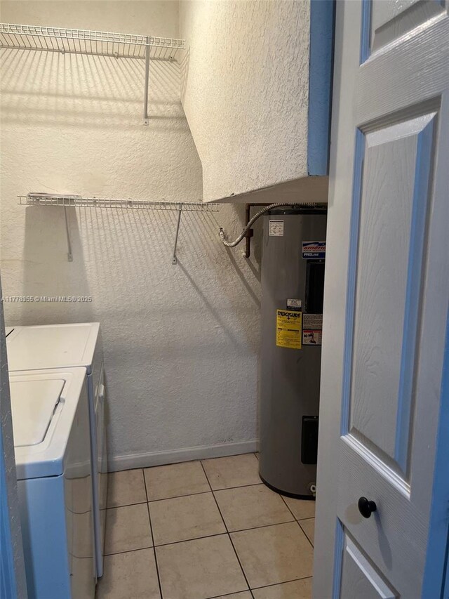 977 SW 153rd Path, Miami, FL 33194 - laundry area featuring electric water heater, washing machine and dryer, a textured wall, and light tile patterned flooring