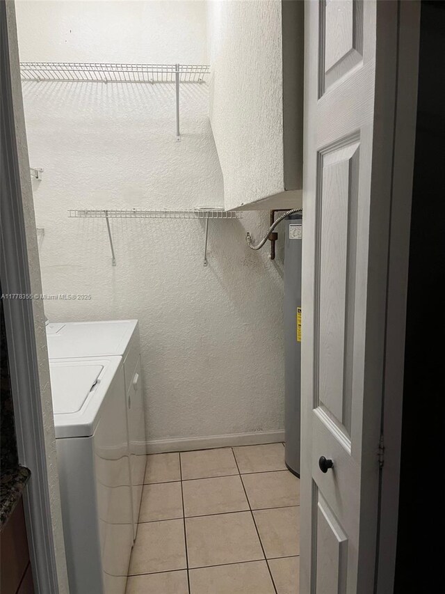 977 SW 153rd Path, Miami, FL 33194 - washroom with independent washer and dryer, light tile patterned floors, baseboards, water heater, and a textured wall