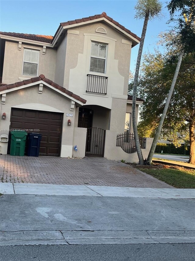 977 SW 153rd Path, Miami, FL 33194 - view of front of house featuring decorative driveway, stucco siding, a tiled roof, and an attached garage