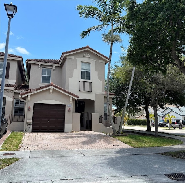 977 SW 153rd Path, Miami, FL 33194 - view of front of house featuring a tile roof, stucco siding, decorative driveway, and an attached garage