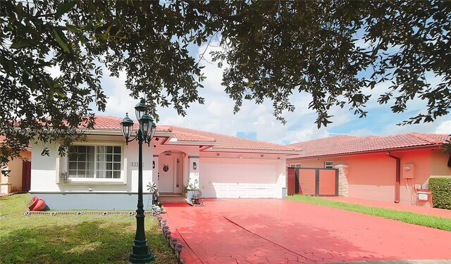 14426 NW 88th Ave, Miami Lakes, FL 33018 - view of front facade with stucco siding, a garage, concrete driveway, and a tiled roof
