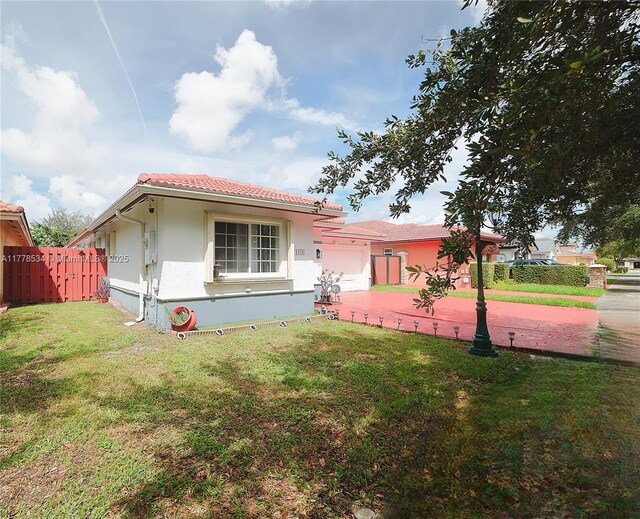 14426 NW 88th Ave, Miami Lakes, FL 33018 - view of front facade with a garage, stucco siding, a tiled roof, and driveway