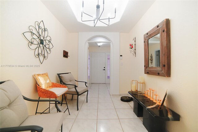 14426 NW 88th Ave, Miami Lakes, FL 33018 - foyer entrance featuring arched walkways, light tile patterned flooring, a chandelier, and baseboards
