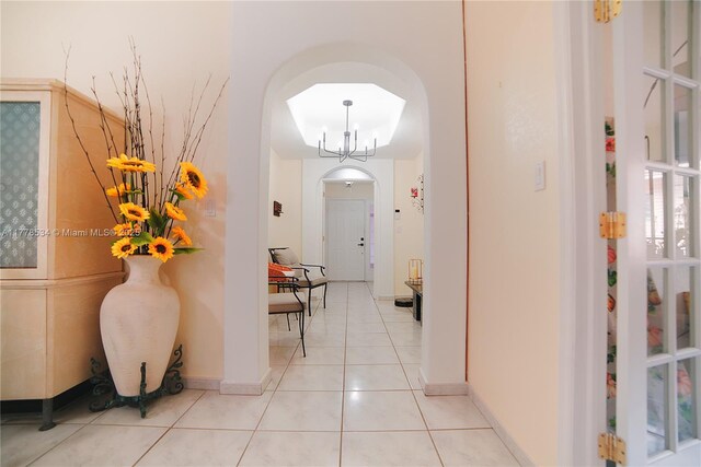 14426 NW 88th Ave, Miami Lakes, FL 33018 - hall featuring arched walkways, light tile patterned flooring, and baseboards