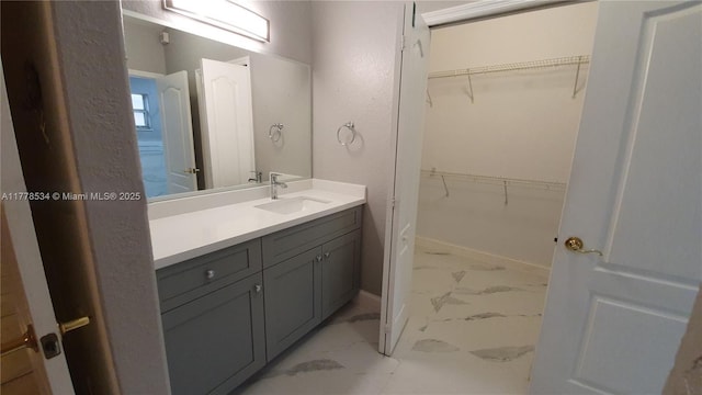 14426 NW 88th Ave, Miami Lakes, FL 33018 - bathroom with marble finish floors, vanity, baseboards, and a spacious closet