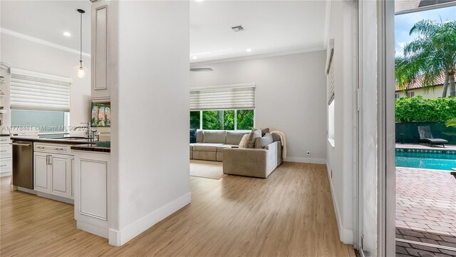 2269 Quail Roost Dr, Weston, FL 33327 - corridor featuring crown molding, baseboards, a sink, recessed lighting, and light wood-type flooring