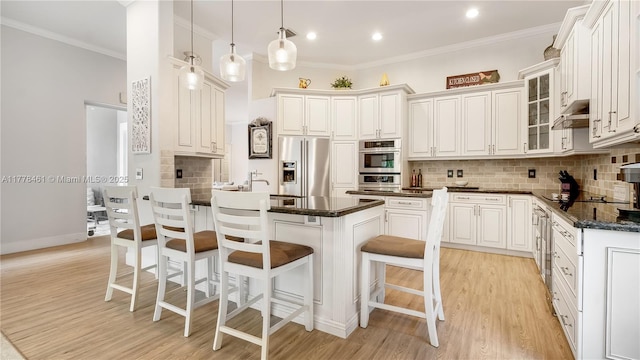 2269 Quail Roost Dr, Weston, FL 33327 - kitchen with stainless steel appliances, a breakfast bar area, crown molding, light wood finished floors, and backsplash