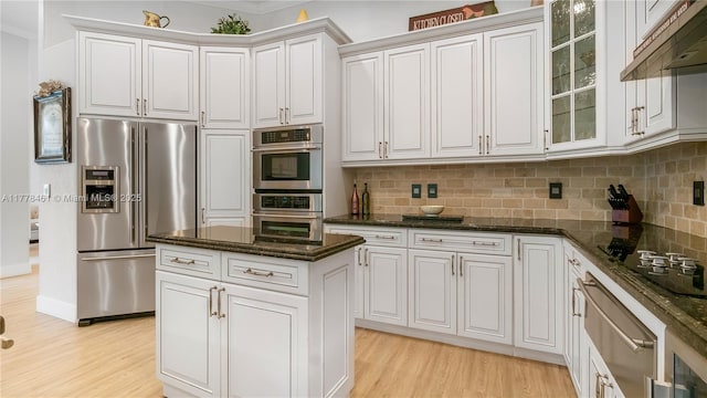 2269 Quail Roost Dr, Weston, FL 33327 - kitchen with appliances with stainless steel finishes, light wood-style floors, decorative backsplash, and under cabinet range hood