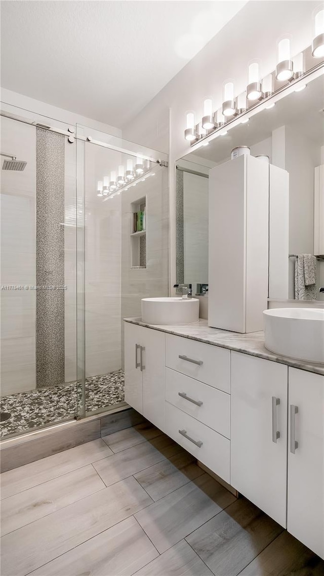 2269 Quail Roost Dr, Weston, FL 33327 - full bathroom with a shower stall, double vanity, and wood finished floors