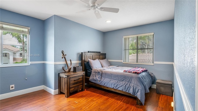 2269 Quail Roost Dr, Weston, FL 33327 - bedroom with multiple windows, wood finished floors, baseboards, and a textured wall