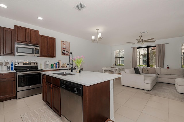 1091 NW 33rd Ct, Pompano Beach, FL 33064 - kitchen featuring visible vents, a sink, light countertops, stainless steel appliances, and open floor plan