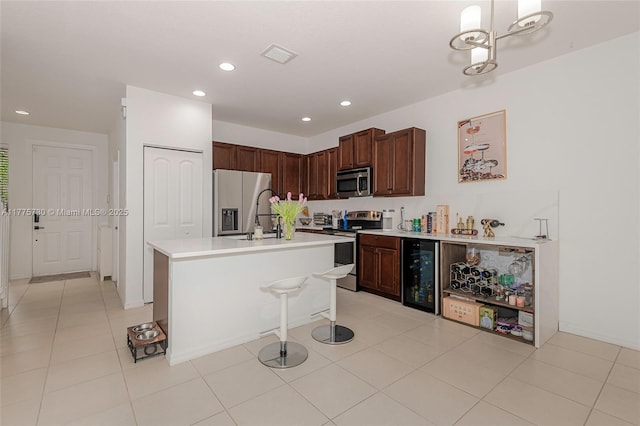1091 NW 33rd Ct, Pompano Beach, FL 33064 - kitchen with visible vents, appliances with stainless steel finishes, light countertops, a sink, and wine cooler