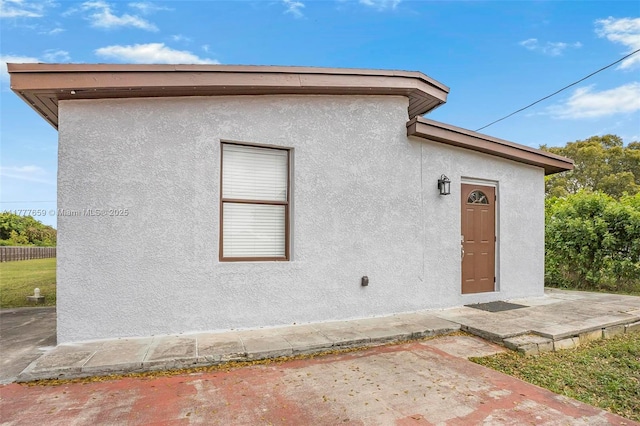 back of house with stucco siding